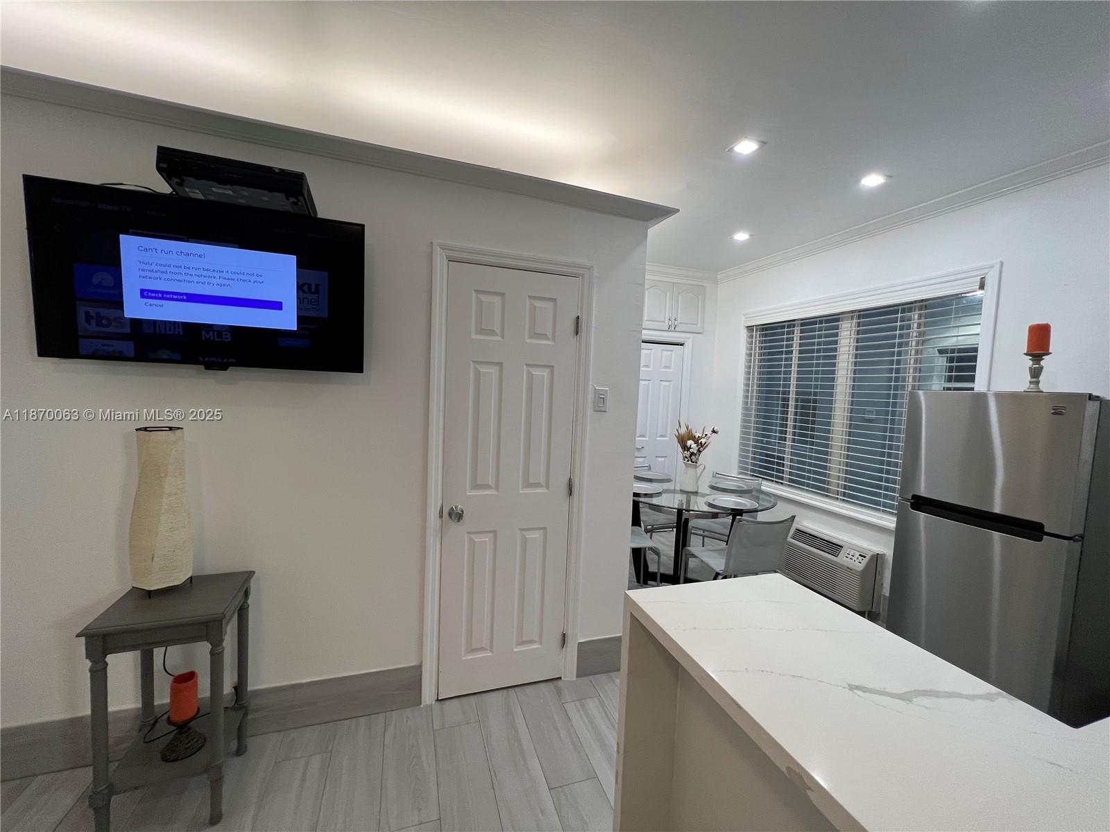 3710 Collins Avenue, Unit N103 Miami Beach, FL 33140 - Photo 12 of 53 a kitchen with stainless steel appliances granite countertop a refrigerator and a microwave