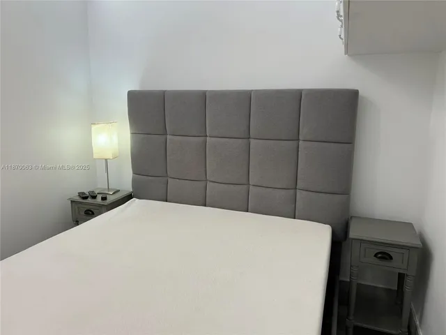 a room with a bed and cabinets
