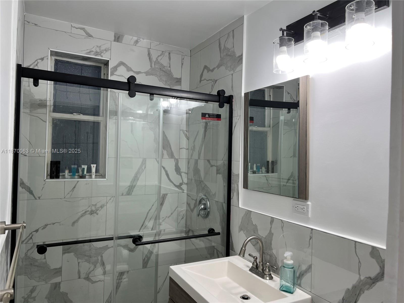 3710 Collins Avenue, Unit N103 Miami Beach, FL 33140 - Photo 15 of 53 a bathroom with a shower and a sink