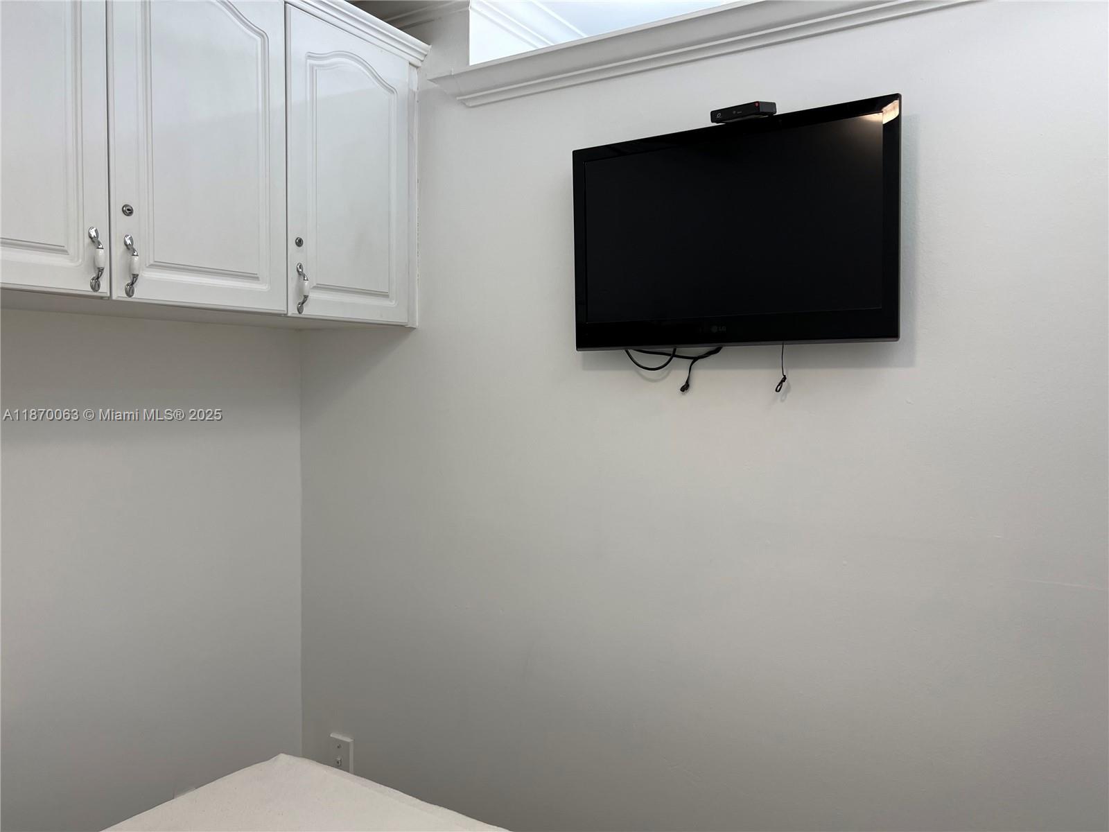 3710 Collins Avenue, Unit N103 Miami Beach, FL 33140 - Photo 17 of 53 a living room that has a fireplace and a flat screen tv