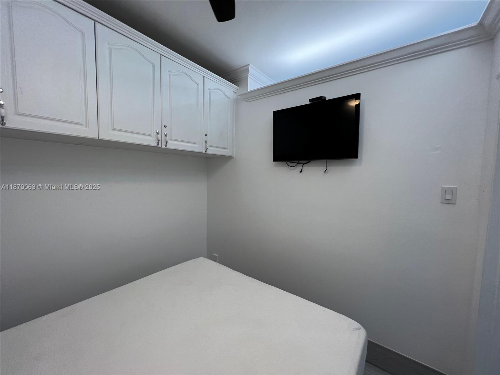 3710 Collins Avenue, Unit N103 Miami Beach, FL 33140 - Photo 27 of 53 a room with a flat screen tv and a bathroom
