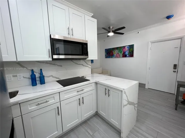 a kitchen with a refrigerator and a sink