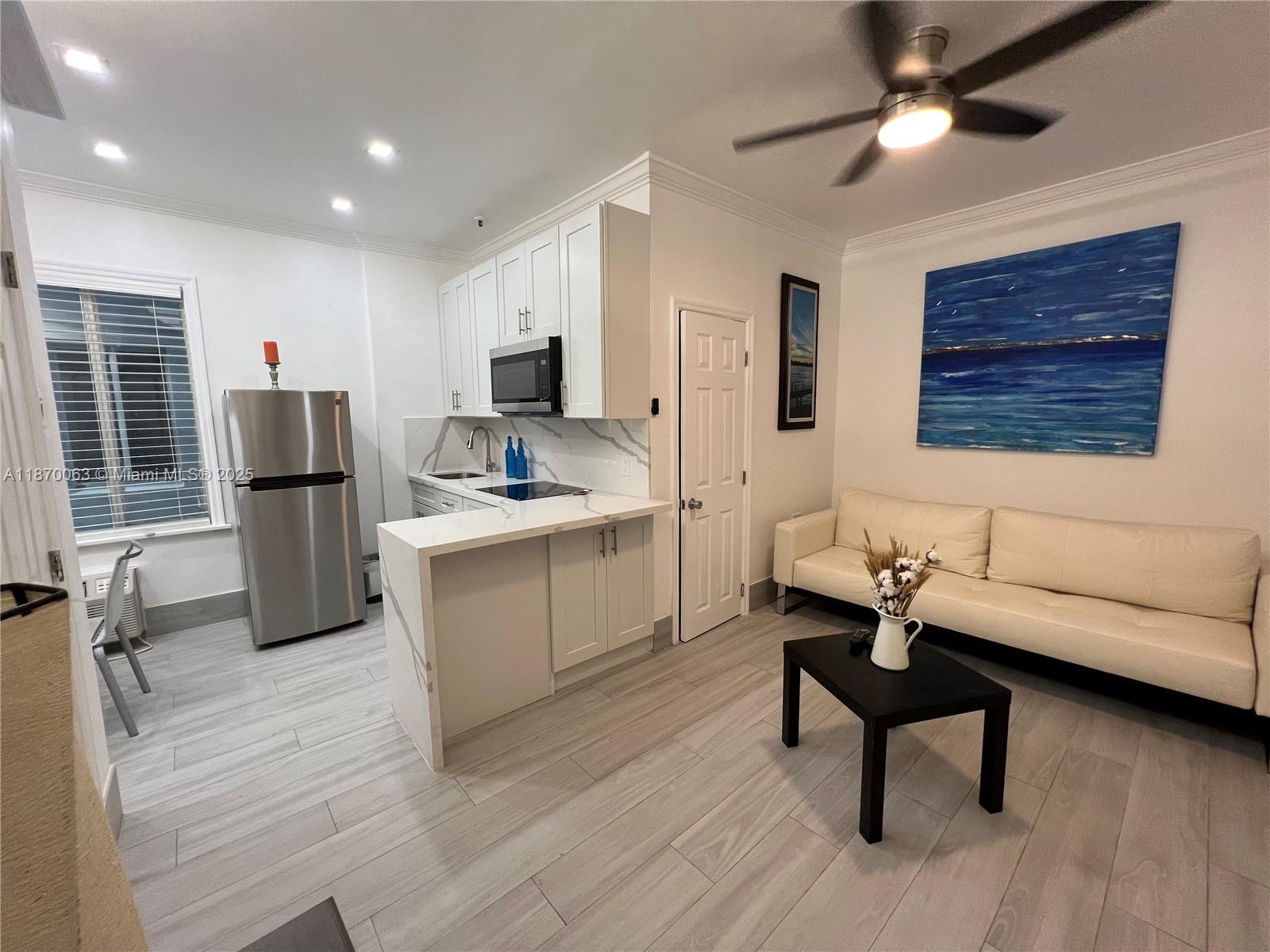 3710 Collins Avenue, Unit N103 Miami Beach, FL 33140 - Photo 30 of 53 a kitchen with a refrigerator and a sink