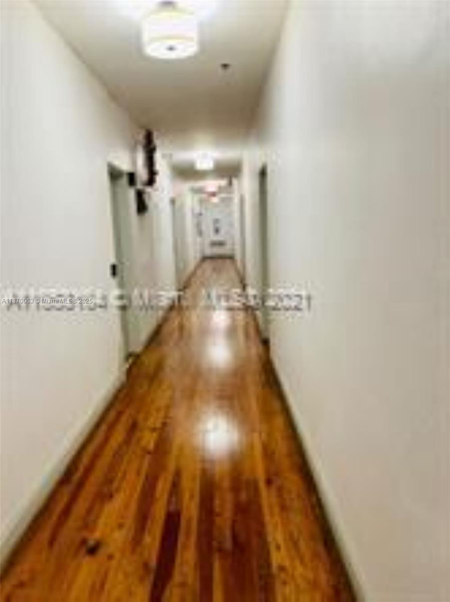 3710 Collins Avenue, Unit N103 Miami Beach, FL 33140 - Photo 40 of 53 a view of a hallway with wooden floor