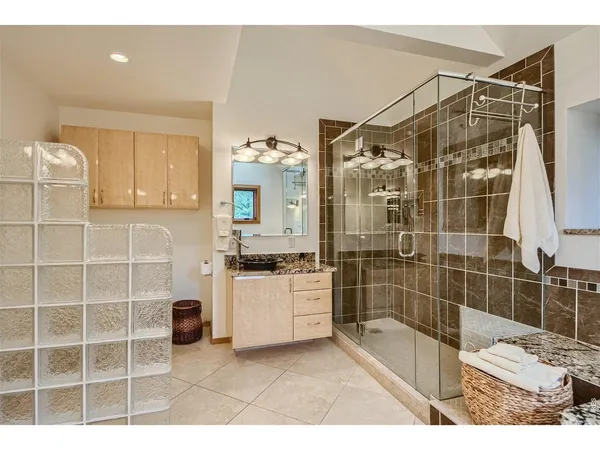 a bathroom with a tub sink and mirror