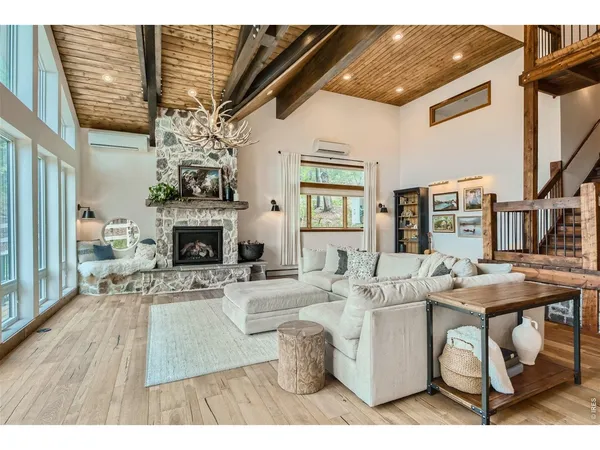 a living room with furniture a fireplace and a flat screen tv