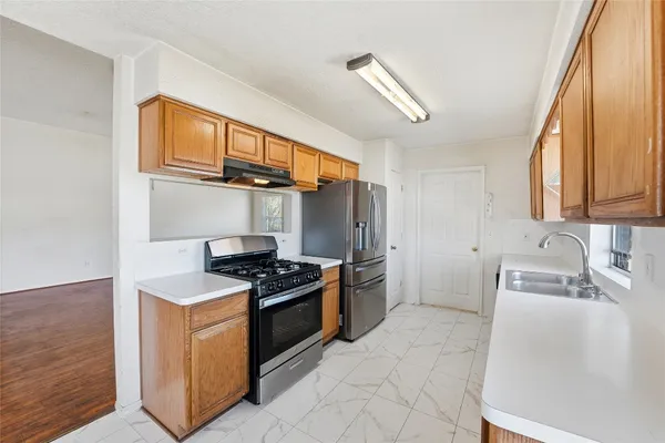 a kitchen with stainless steel appliances granite countertop a stove and a sink