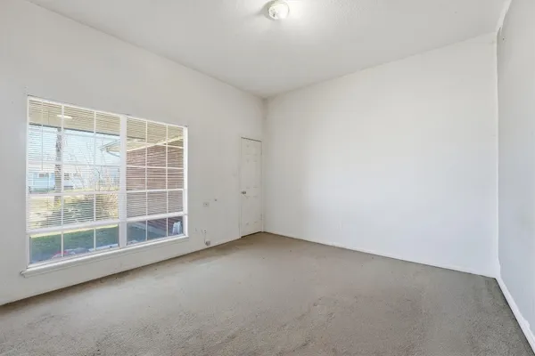 a spacious bedroom with a bed and a flat screen tv