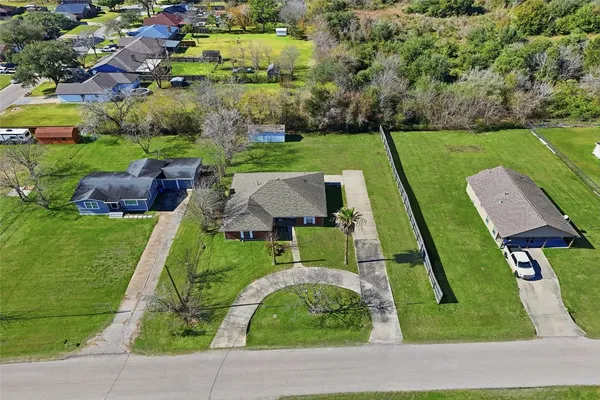 an aerial view of multiple houses with yard
