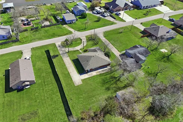 an aerial view of multiple houses with yard