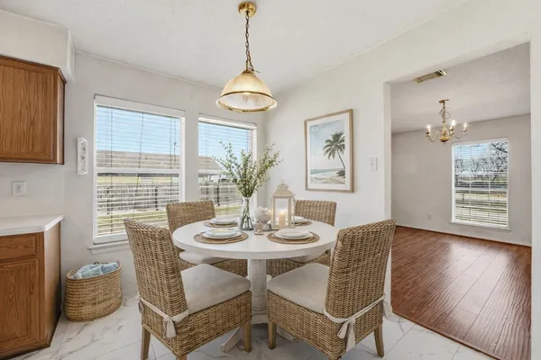 a view of a dining room with furniture window and wooden floor