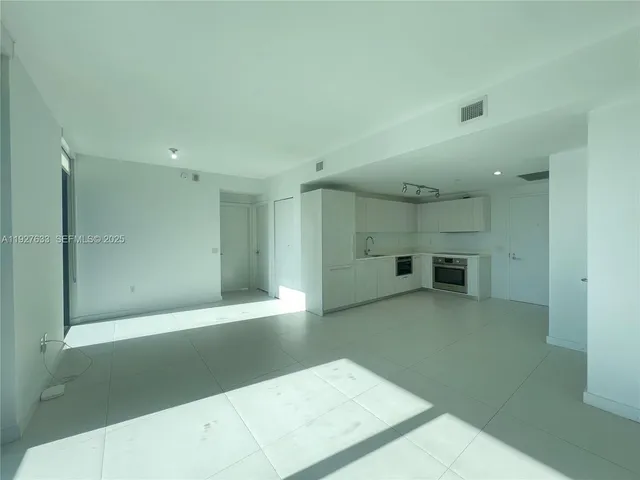 a view of a big room with a kitchen