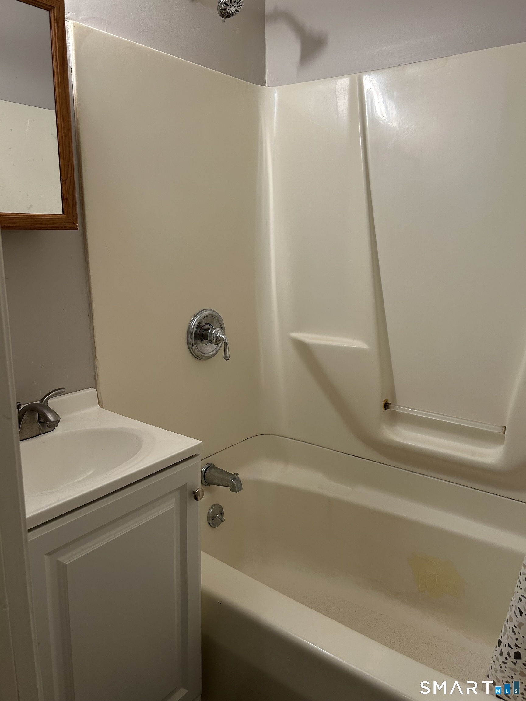 68 Anderson Street Naugatuck, CT 06770 - Photo 7 of 7 a bathroom with a sink a mirror and a bathtub