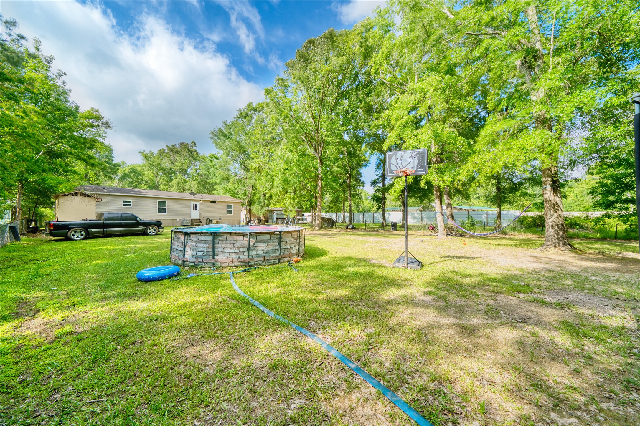 103 County Road 370 Splendora, TX 77372 - Photo 31 of 32 a view of a house with swimming pool and sitting area
