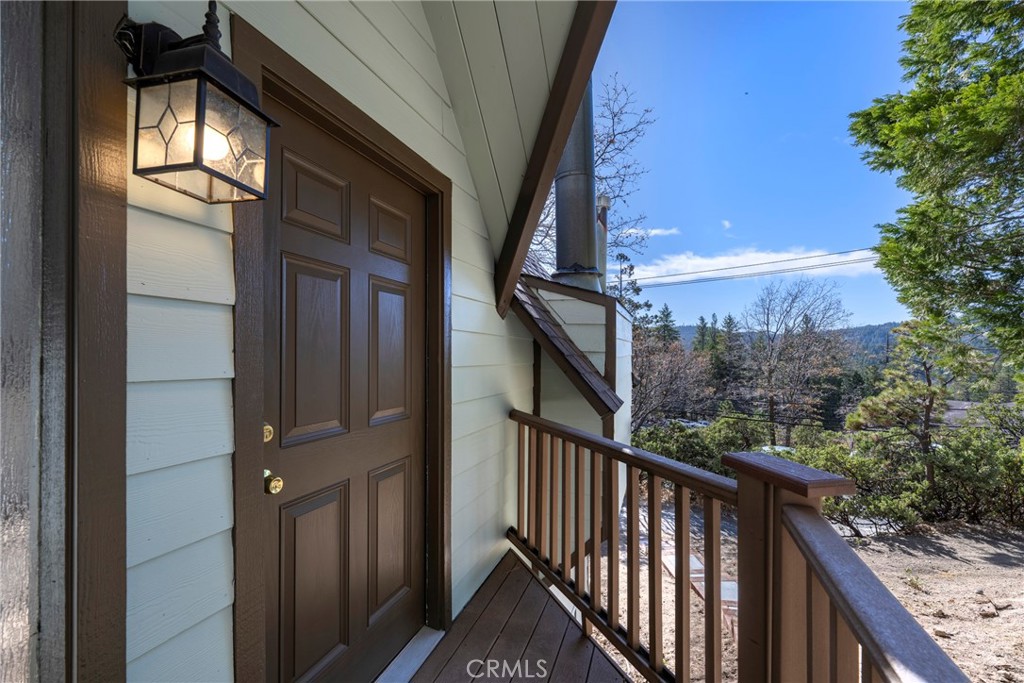 743 Rhine Road Lake Arrowhead, CA 92352 - Photo 2 of 30 a view of a balcony with wooden floor and fence