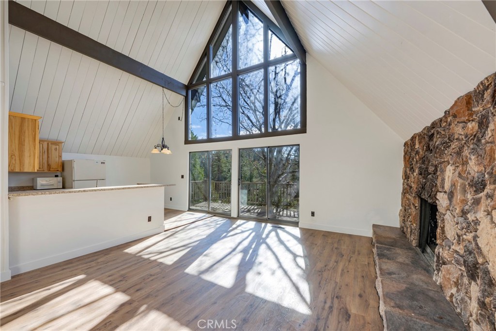 743 Rhine Road Lake Arrowhead, CA 92352 - Photo 5 of 30 a view of a bedroom with a bed and wooden floor