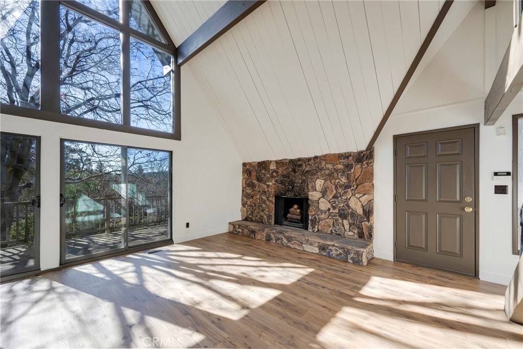 743 Rhine Road Lake Arrowhead, CA 92352 - Photo 7 of 30 a view of a livingroom with wooden floor and a fireplace