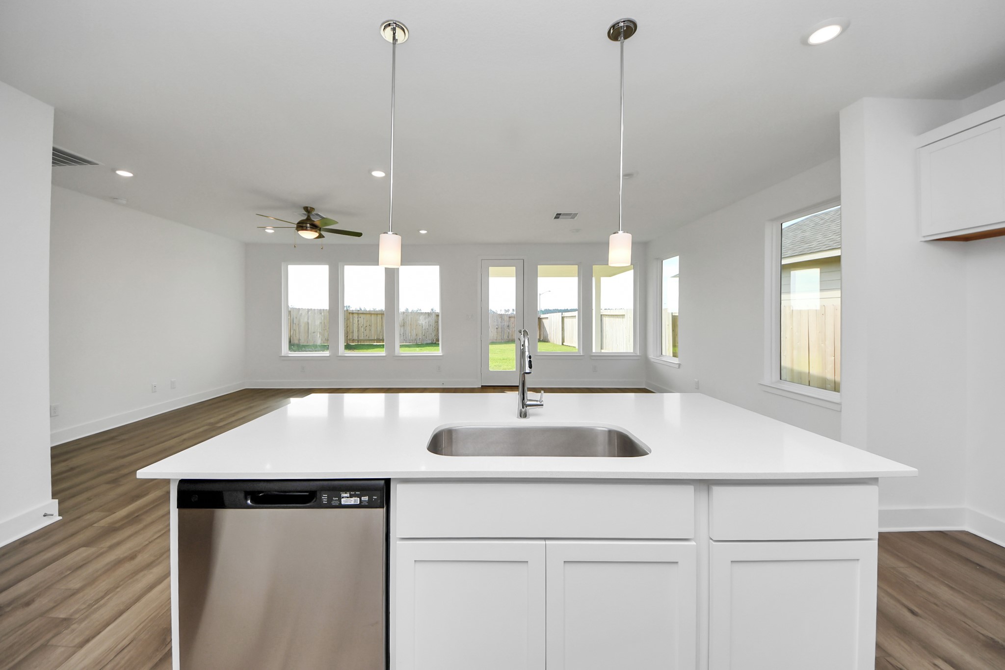 14471 Trumpet Lane Splendora, TX 77372 - Photo 7 of 33 a kitchen with kitchen island a sink appliances and a window