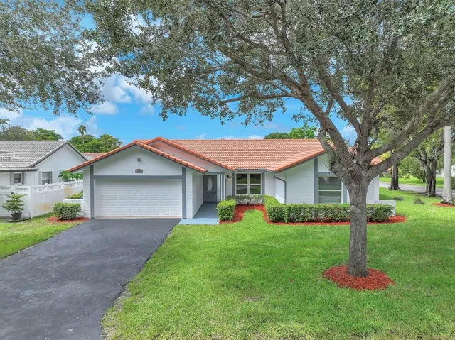 a front view of house with yard and green space