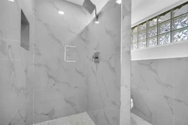 a view of a room with wooden floor and windows