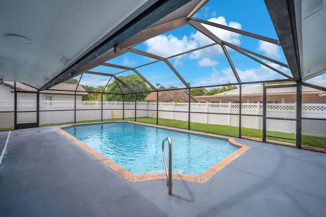 an aerial view of a house with garden space and street view