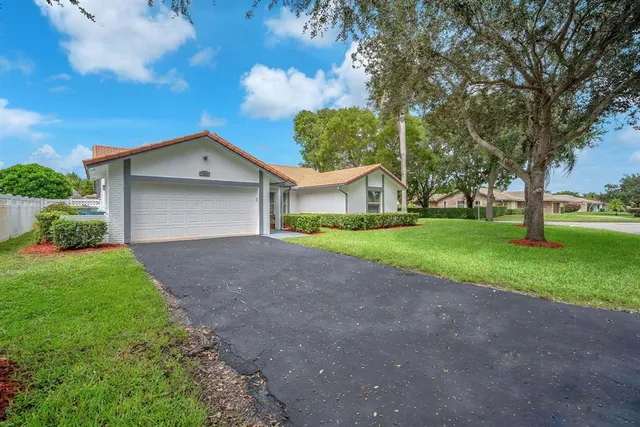 a front view of house with yard and green space