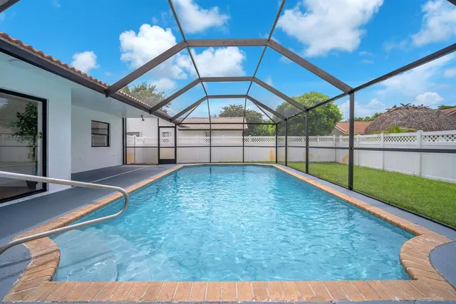 an aerial view of residential houses with outdoor space and street view