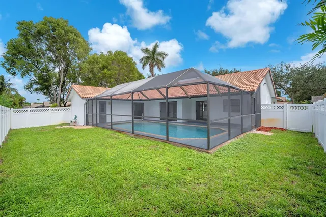 an aerial view of residential houses with outdoor space and swimming pool
