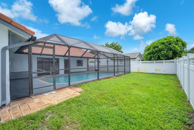 an aerial view of residential houses with outdoor space and lakeside