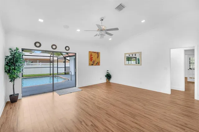 a view of a dining room with furniture wooden floor and a chandelier