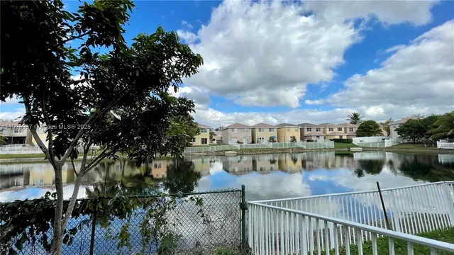 a view of a lake with a table and chairs