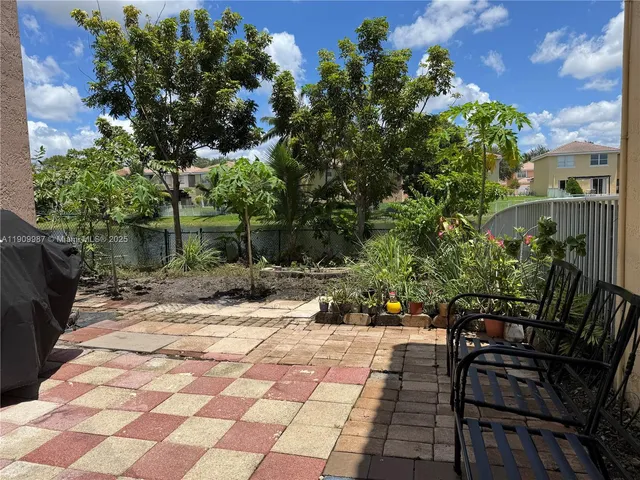 a kitchen with stainless steel appliances granite countertop a sink a stove and cabinets