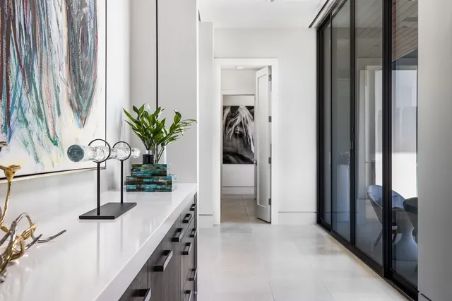 a living room with furniture a rug and a large window