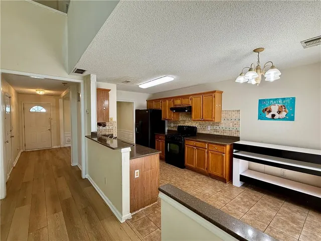 a kitchen with stainless steel appliances granite countertop a stove and a refrigerator