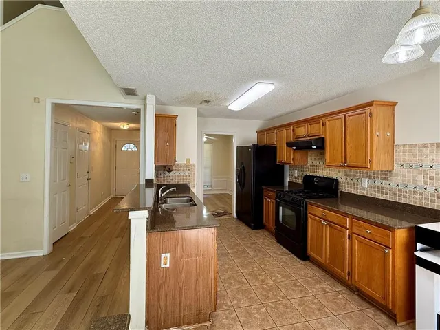 a kitchen with a sink stove and refrigerator