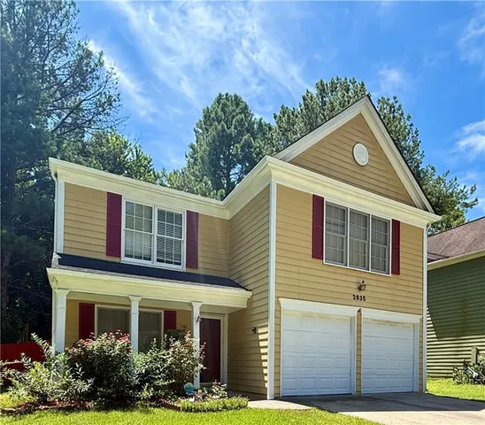 a front view of a house with garden
