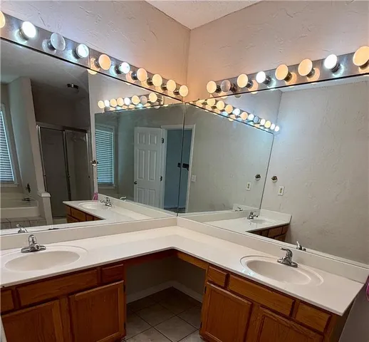a bathroom with a sink double vanity and a mirror