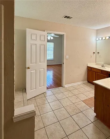 a room with a bed and cabinets