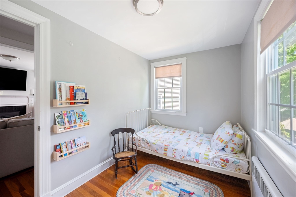 40 Lyman Road Milton, MA 02186 - Photo 11 of 28 a bedroom with baby bed furniture and a window