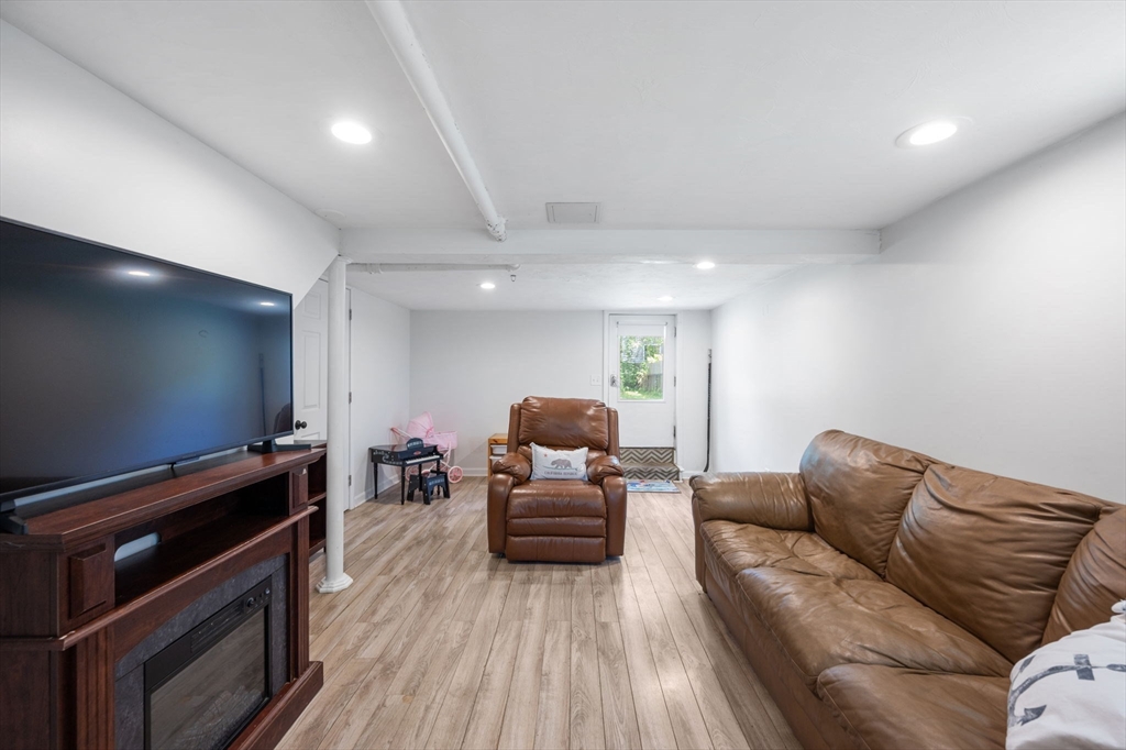 40 Lyman Road Milton, MA 02186 - Photo 18 of 28 a living room with furniture and a flat screen tv