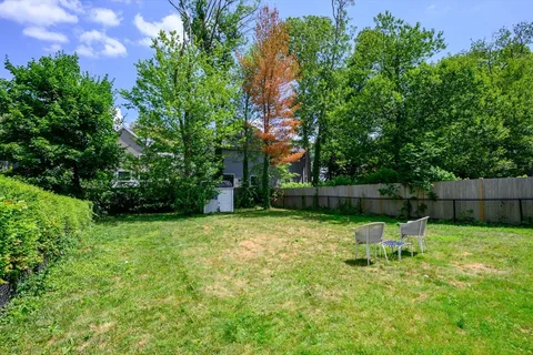 a backyard of a house with table and chairs