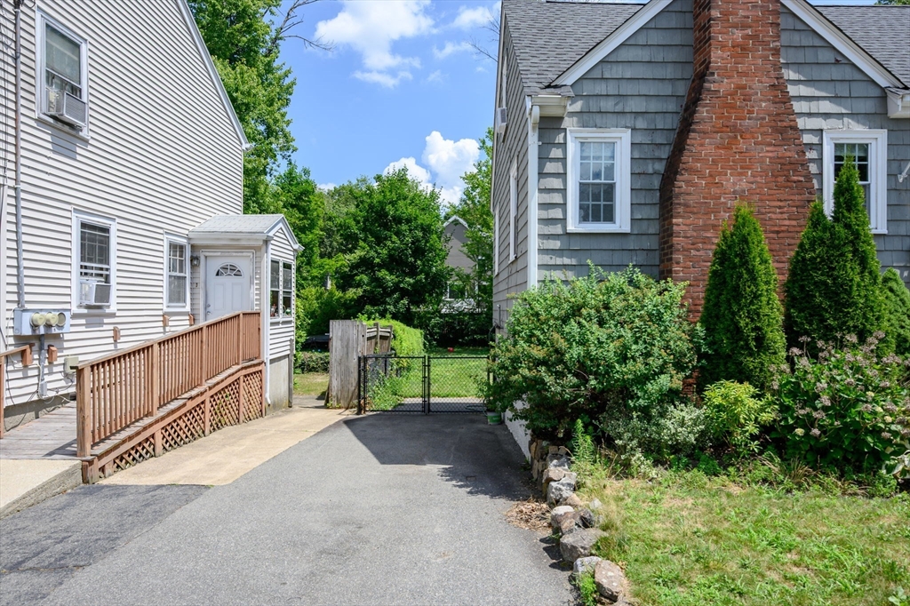 40 Lyman Road Milton, MA 02186 - Photo 22 of 28 a view of a house with a yard and potted plants