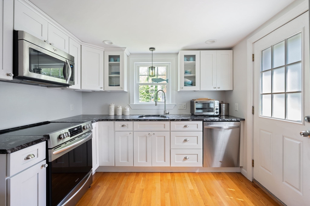 40 Lyman Road Milton, MA 02186 - Photo 3 of 28 a kitchen with stainless steel appliances granite countertop a stove a sink and a microwave