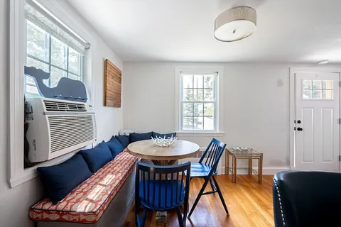 a view of a dining room with furniture and window