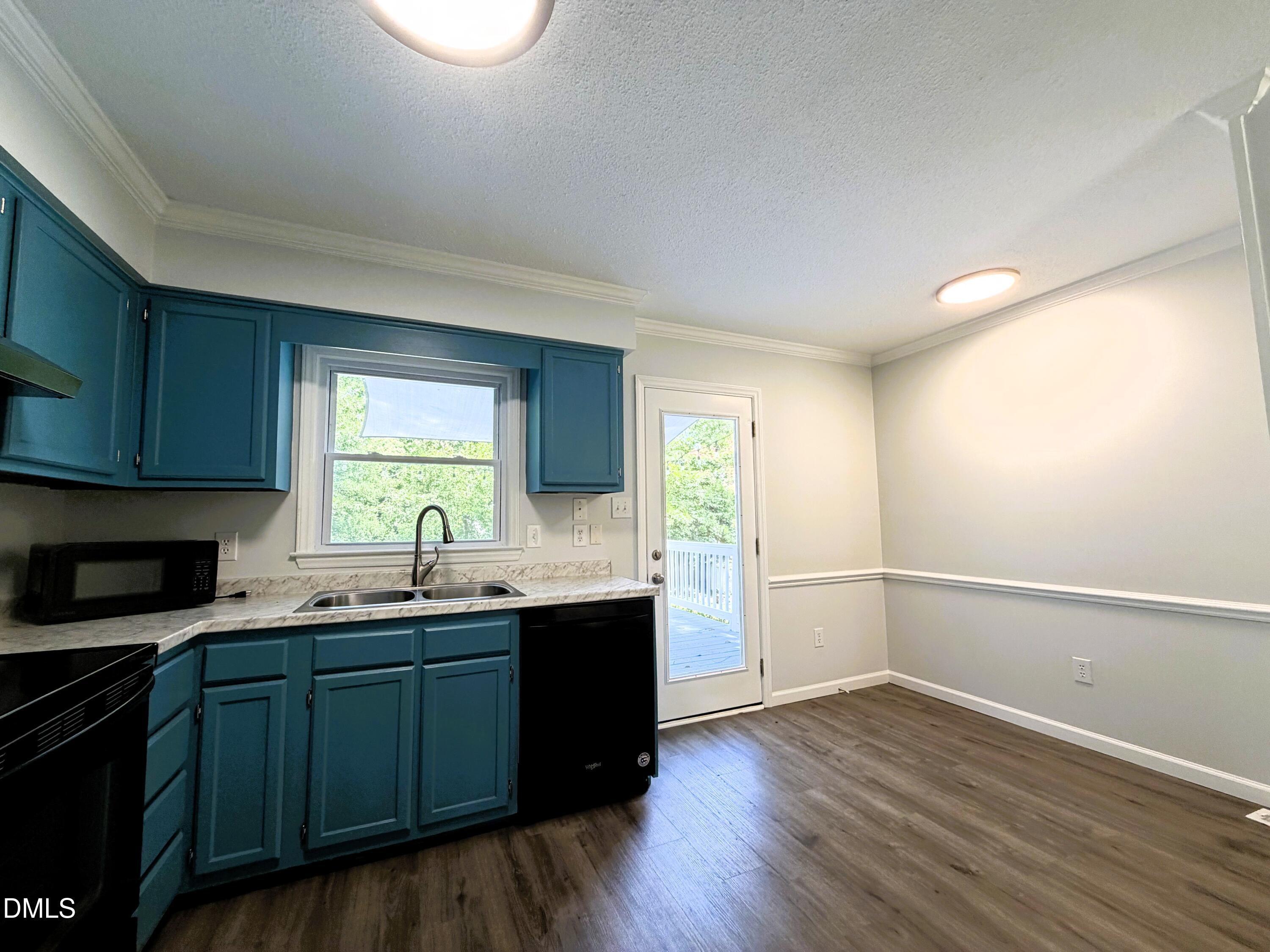 333 Jones Franklin Road, Unit B Raleigh, NC 27606 - Photo 2 of 9 a kitchen with wooden floors and sink