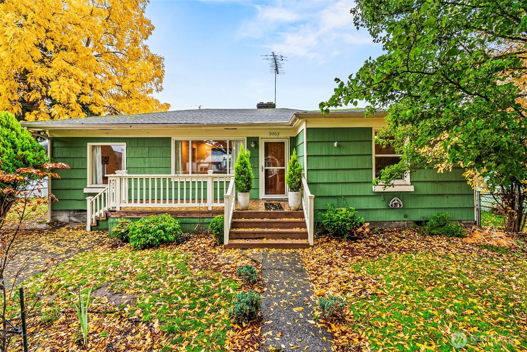 a front view of a house with a garden
