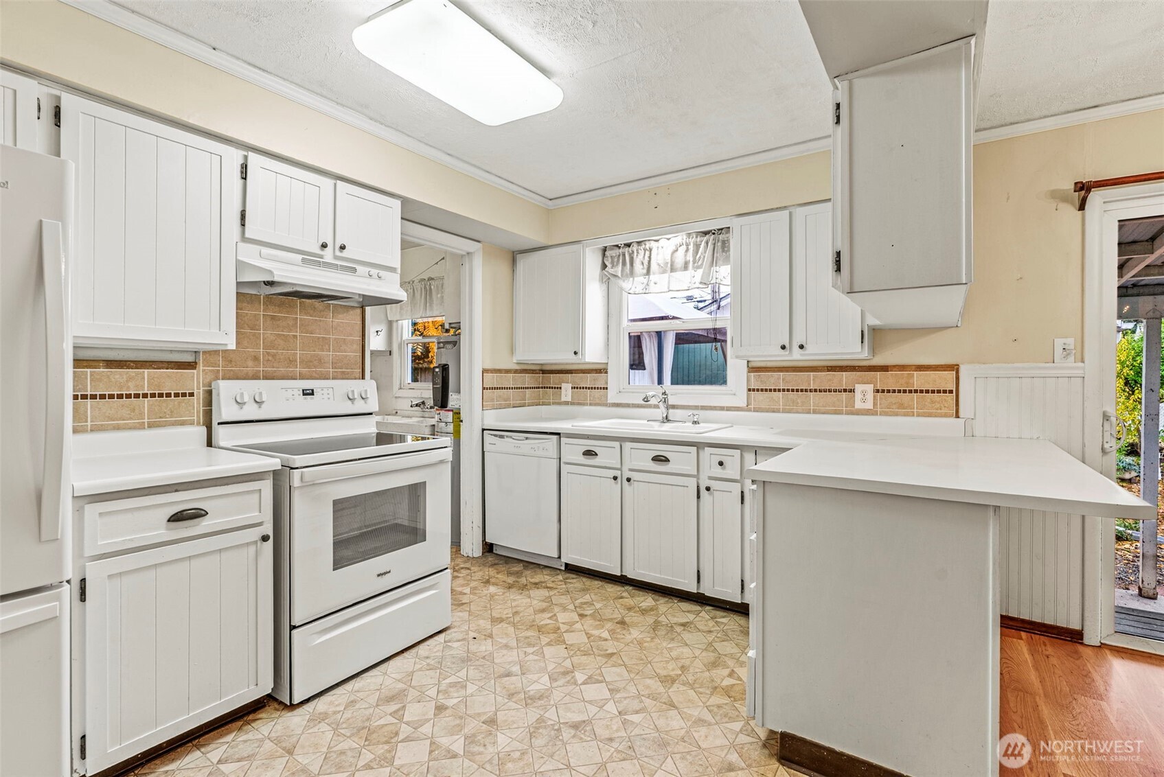3053 Fir Street Longview, WA 98632 - Photo 9 of 20 a kitchen with granite countertop a sink stainless steel appliances and white cabinets