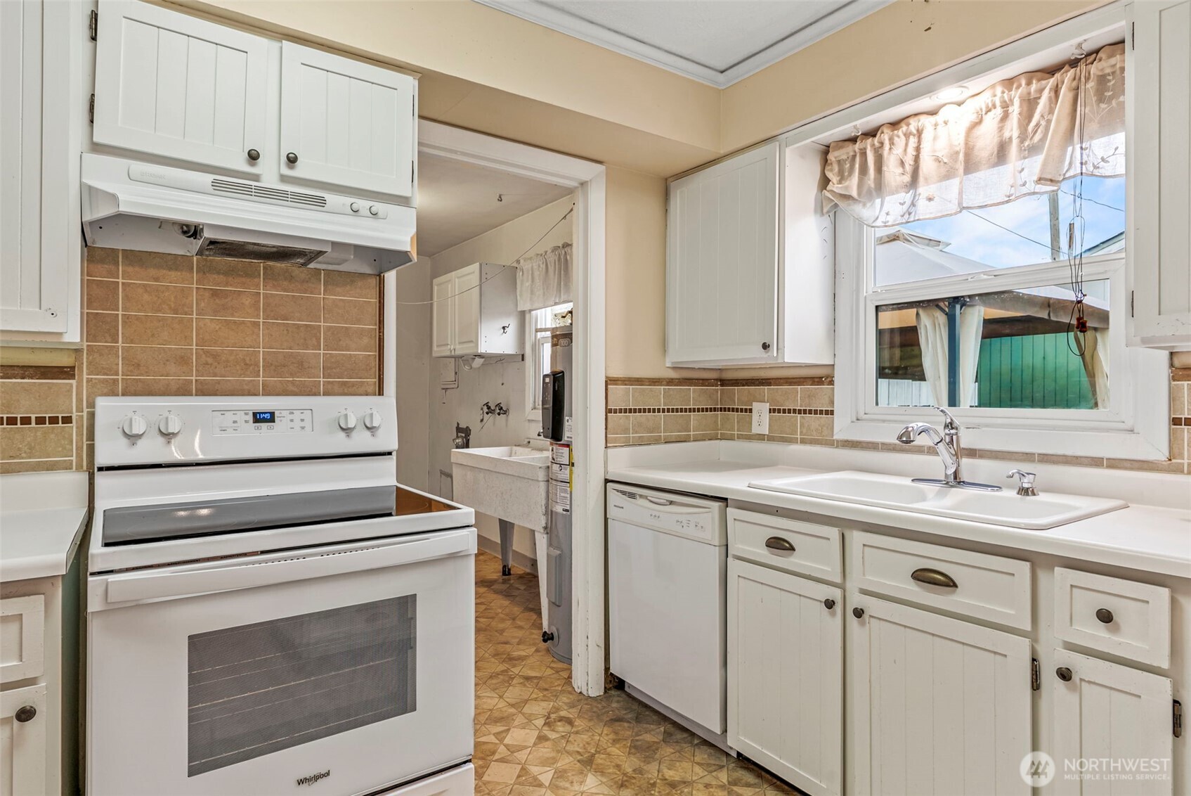 3053 Fir Street Longview, WA 98632 - Photo 10 of 20 a kitchen with a sink stove and cabinets