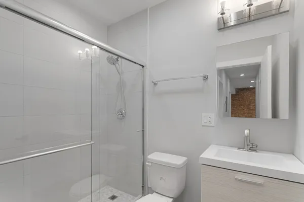 a bathroom with a toilet a sink and shower