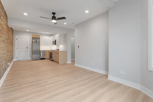 wooden floor in an empty room with a kitchen